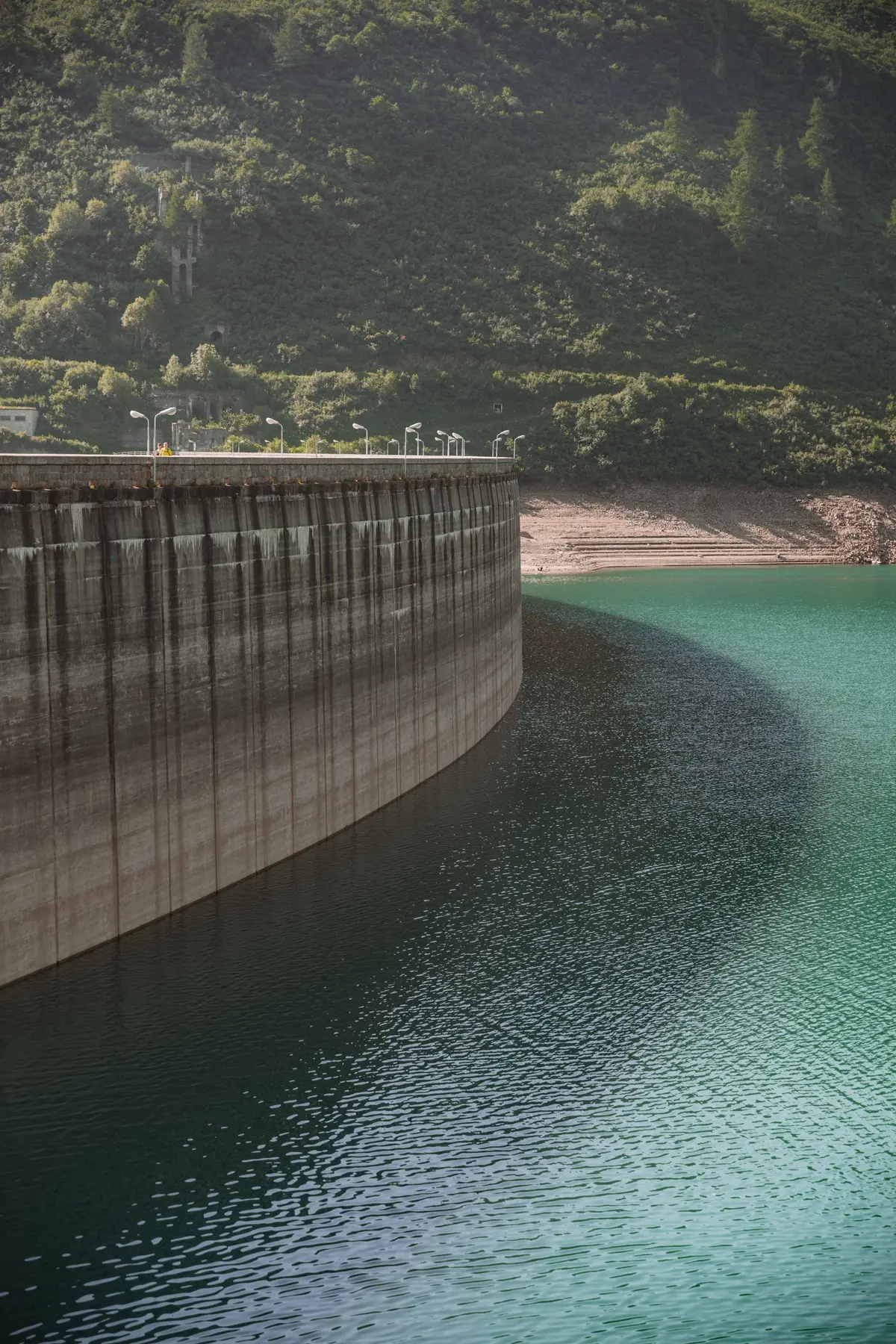 Diga e lago verde in una valle di montagna