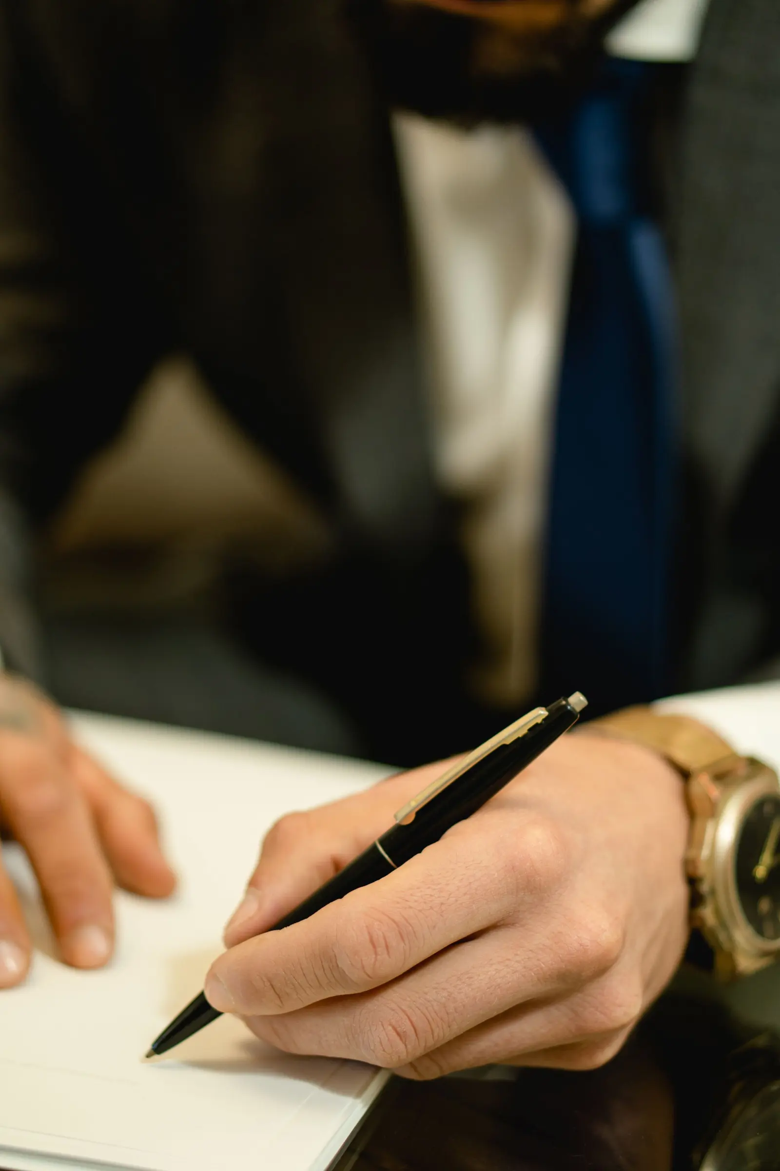 Una mano firma un foglio con la penna stilografica